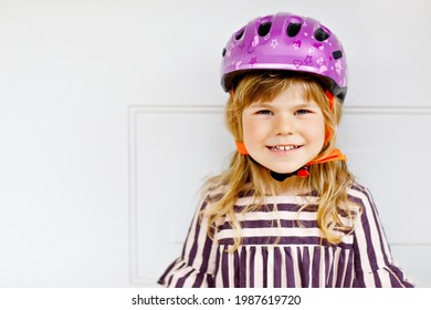 Portrait Of Happy Smiling Preschool Girl With Bycicle Helmet On Head. Cute Toddler Child. Safe Bike Driving With Children Concept. Safety Helmet For Kids