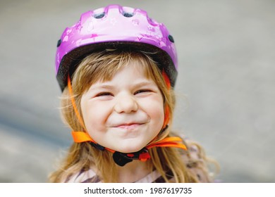 Portrait Of Happy Smiling Preschool Girl With Bycicle Helmet On Head. Cute Toddler Child. Safe Bike Driving With Children Concept. Safety Helmet For Kids