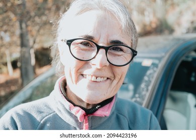 Portrait Of A Happy Smiling Senior Woman Outside Car Learning To Drive A Car. Safety Drive. Learning New Hobby, Habit And Skill For This New Year. Elderly Person Approving The Driving License.