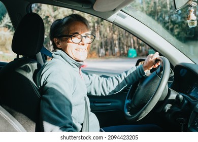 Portrait Of A Happy Smiling Senior Woman Learning To Drive A Car. Safety Drive. Learning New Hobby, Habit And Skill For This New Year. Elderly Person Approving The Driving License.