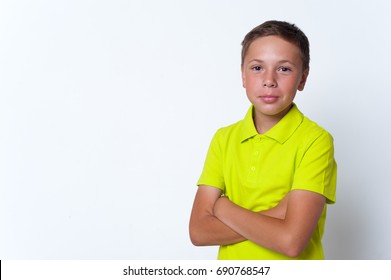 Portrait Of Happy Smiling Tween Boy Crossing Arms On The Chest And Looking At The Camera.