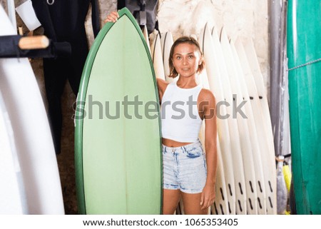 Similar – Surfer woman with bikini and wetsuit holding surfboard