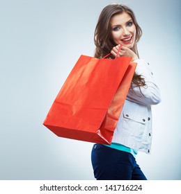  Portrait of happy smiling woman hold shopping bag. Female model isolated studio background.