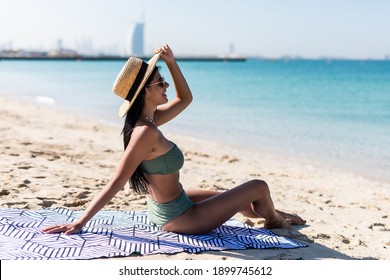 Portrait Of Happy Smiling Woman Laying On A Towel At The Beach