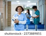 Portrait of happy smiling woman medical student holding school book have group students on background in classroom hospital medical school. concept of medical and education.