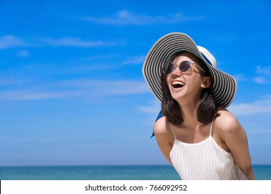 Portrait Of Happy Smiling Woman On The Beach On A Beautiful . Pretty Girl Asian In Casual Looking Away And Smile , Laughing. The Beach Beautiful At Bright Sky