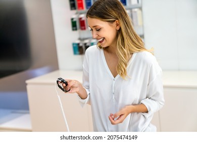 Portrait Of Happy Smiling Woman Shopping A New Smart Watch In Tech Store. Technology People Concept