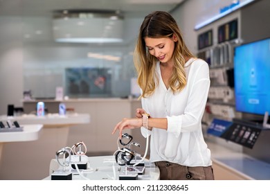 Portrait Of Happy Smiling Woman Shopping A New Smart Watch In Tech Store. Technology People Concept