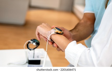 Portrait Of Happy Smiling Woman Shopping A New Smart Watch In Tech Store. Technology People Concept