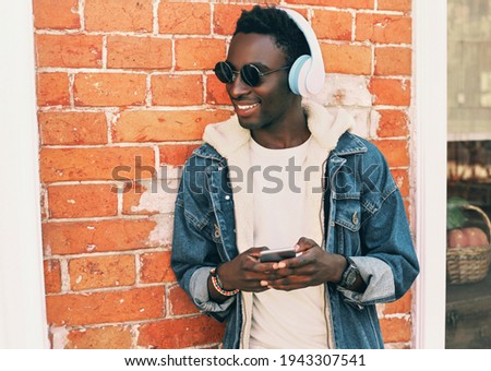 Similar – Young black man listening to music