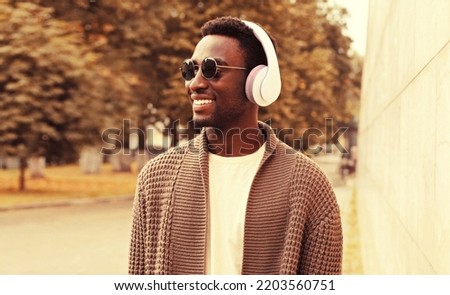 Similar – Young happy black man is listening to music