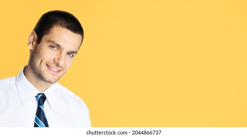 Portrait Of Happy Smiling Young Brunette Businessman In White Shirt And Tie Isolated Over Orange Yellow Colour Background With Copy Space Area. Confident Business Man At Studio Image. Male Executive.