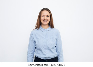 Portrait of a happy and smiling young girl or business woman with blue shirt on, having a nice face looking in camera, isolated on white. 
