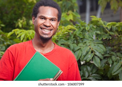Portrait Of A Happy Smiling Young Male Student From South East Asia Carrying School Books