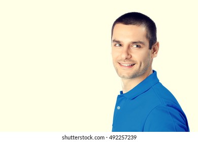Portrait of happy smiling young man. Caucasian young male hansome brunette model in blue casual clothing in studio shoot. Blank copyspace area for advertising slogan or text message.  - Shutterstock ID 492257239