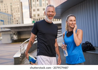 Portrait Of Happy Sportive Middle Aged Couple, Man And Woman In Sportswear Smiling, Standing Together Outdoors Ready For Workout