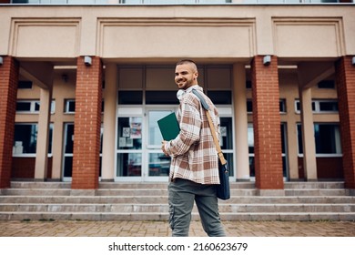 Portrait Of Happy Student In Front Of University Building Looking At Camera. Copy Space.