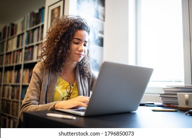 Portrait Of Happy Student Woman Working On Laptop