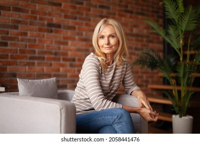 Portrait of happy successful woman. A benevolent mature blonde wife. Positive senior lady. - Shutterstock ID 2058441476