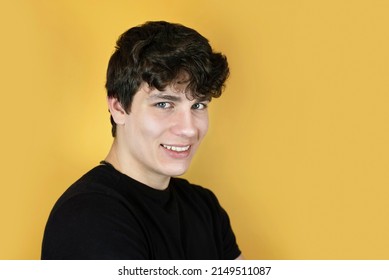 Portrait Of A Happy Teenage Boy On A Yellow Background, The Guy Is Smiling And Happy That He Is Understood And Accepted By His Parents And Friends, He Learns Not To Be Ashamed And To Be Sociable