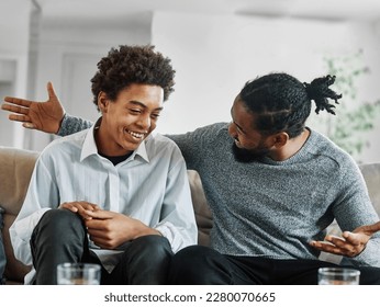 Portrait of a happy teenage boy son talking to his father at home. Sharing secrets and having fun, support and parenthood concept - Shutterstock ID 2280070665