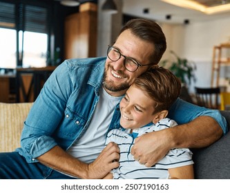 Portrait of a happy teenage boy son and his father at home. Sharing secrets and having fun, support and parenthood concept - Powered by Shutterstock