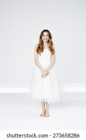 Portrait Of Happy Teenage Girl In White Dress