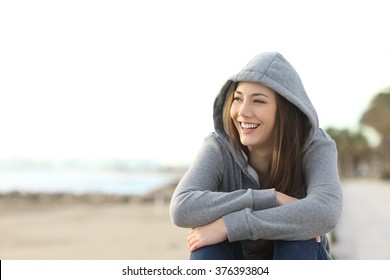 Portrait Of A Happy Teenager Girl Smiling And Looking At Side Outside On The Beach