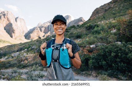 Portrait Of A Happy Trail Runner Standing In Wild Terrain 