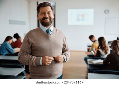 Portrait of happy university teacher in the classroom looking at camera. Students are in the background.  - Powered by Shutterstock