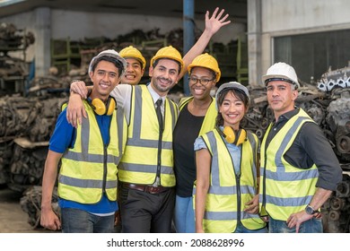 Portrait Of Happy Warehouse Worker In The Factory Storehouse Group Of Employees And Engineers In Industrial Plants. Team Of Workers And Engineer In Factory At Production.