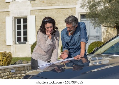 Portrait Of Happy Wealthy Middle Age Couple Studying A New Archi