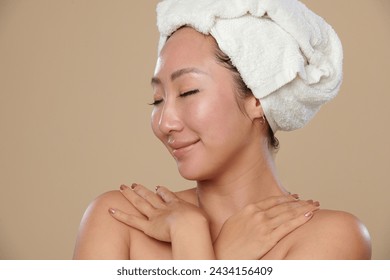 Portrait of happy woman applying body moisturizer after morning shower