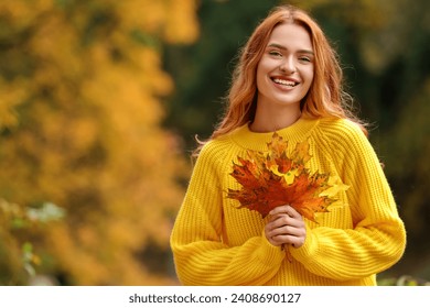 Portrait of happy woman with autumn leaves outdoors. Space for text - Powered by Shutterstock