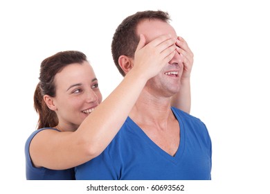 Portrait Of A Happy Woman Covering His Man Eyes, To Surprise Him