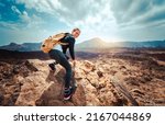 Portrait of a happy woman hiker standing on the top of mountain ridge against mountains - Sport and healthy lifestyle concept
