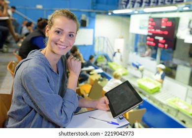 portrait of a happy woman holding tablet