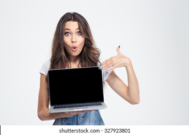 Portrait Of A Happy Woman Pointing Finger On Blank Laptop Computer Screen Isolated On A White Background