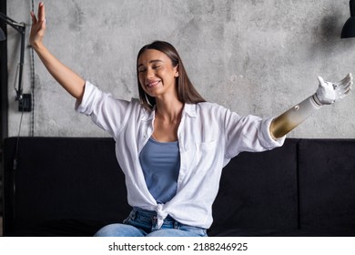 Portrait Happy Woman With Prosthetic Arm, Girl With Disability Relaxing Raising Arms Artificial Prosthetic Limb