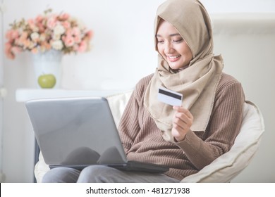 Portrait Of Happy Woman Purchasing Product Via Online Shopping. Pay Using Credit Card