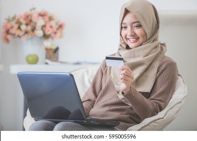 Portrait Of Happy Woman Purchasing Product Via Online Shopping. Pay Using Credit Card