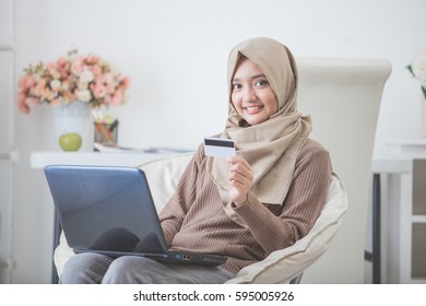 Portrait Of Happy Woman Purchasing Product Via Online Shopping. Pay Using Credit Card