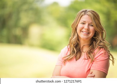 Portrait Of A Happy Woman Smiling Standing Outside.