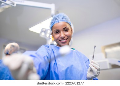 Portrait of happy woman surgeon standing in operating room, ready to work on a patient. Female medical worker in surgical uniform in operation theater. - Powered by Shutterstock