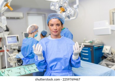 Portrait of happy woman surgeon standing in operating room, ready to work on a patient. Female medical worker in surgical uniform in operation theater. - Shutterstock ID 2259769467