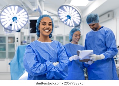 Portrait of happy woman surgeon standing in operating room, ready to work on a patient. Female medical worker in surgical uniform in operation theater. - Powered by Shutterstock