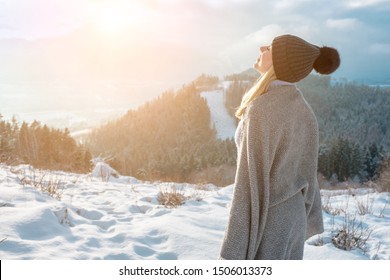 Portrait Happy woman traveler on the top of mountain and looking on beautiful winter snowy view.