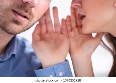 Portrait Of Happy Woman Whispering Secret Or Interesting Gossip To Handsome Man In His Ear - Shutterstock ID 1376251928