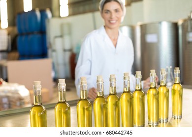 Portrait of happy worker standing at table in factory - Powered by Shutterstock