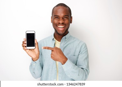 Portrait Of Happy Young African American Man Holding Mobile Phone And Pointing To Screen